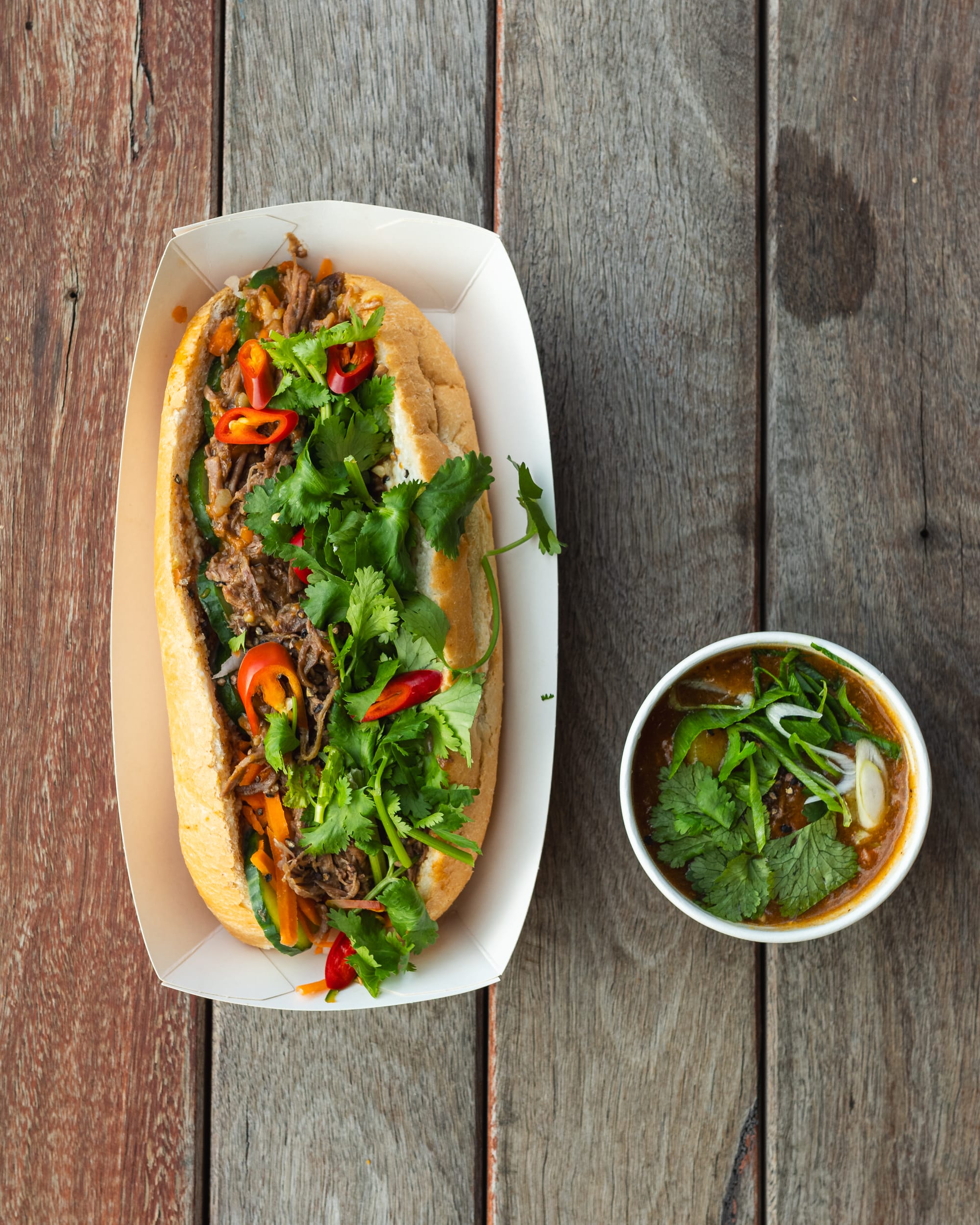 Top down shot of banh mi with chuck beef, chilli and coriander showing