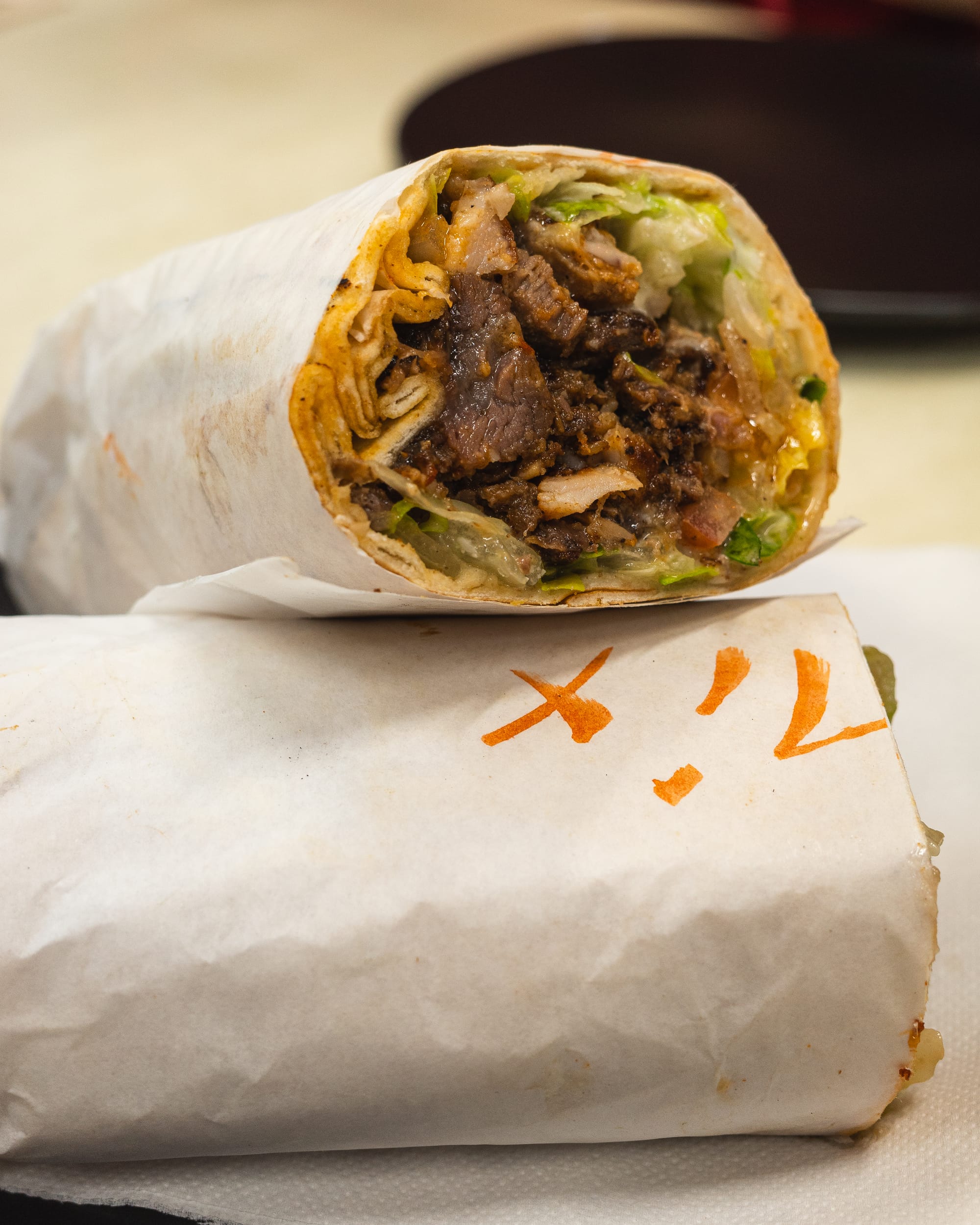 Close up of kebab with tomato, falafel and lettuce showing