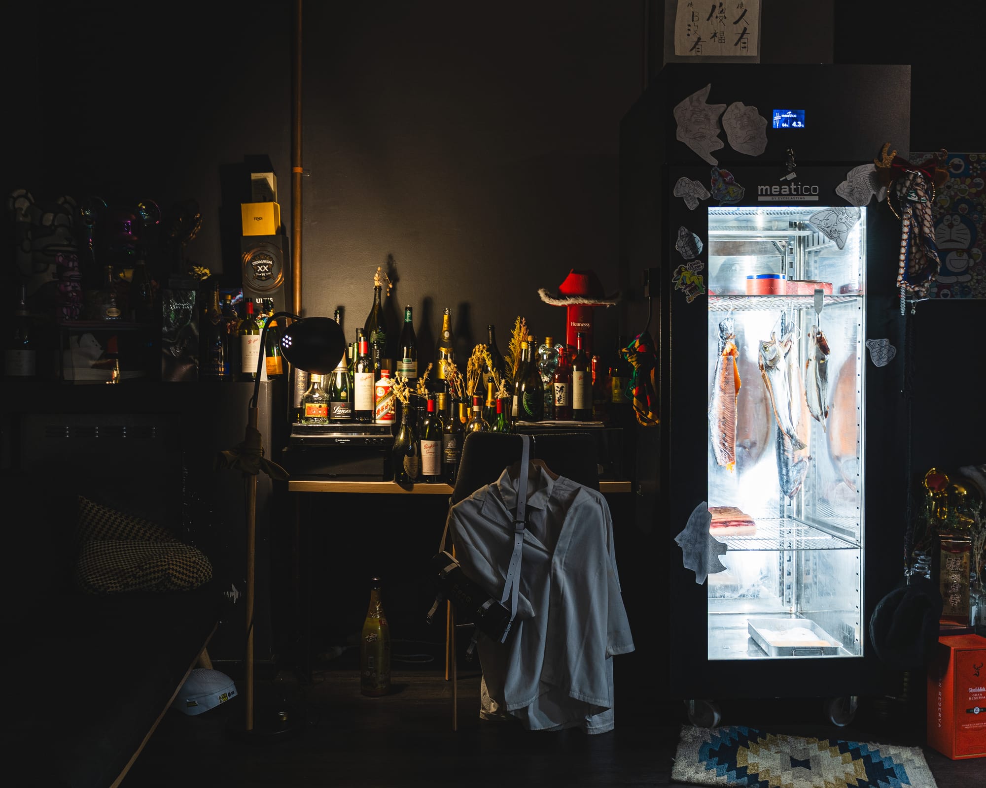 Dimly lit restaurant interior with moody bar setting.