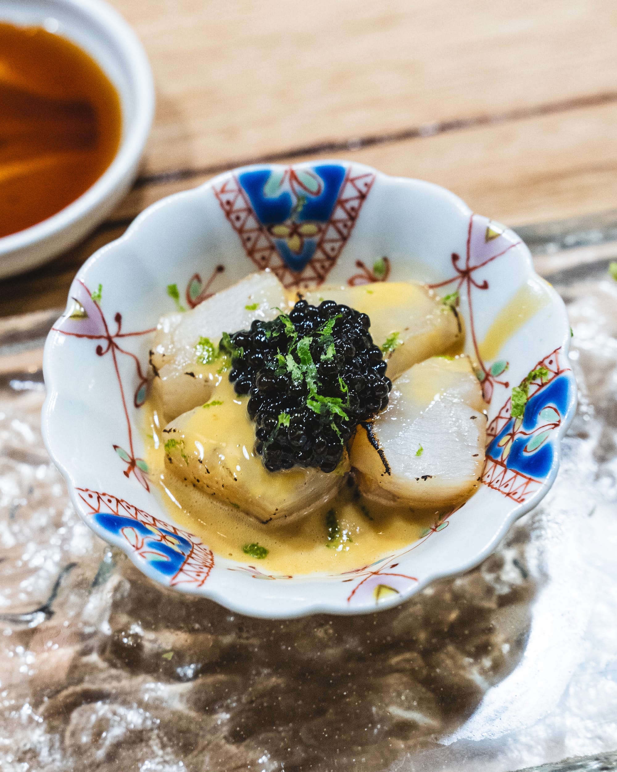 Close up of hotate with caviar and lime zest