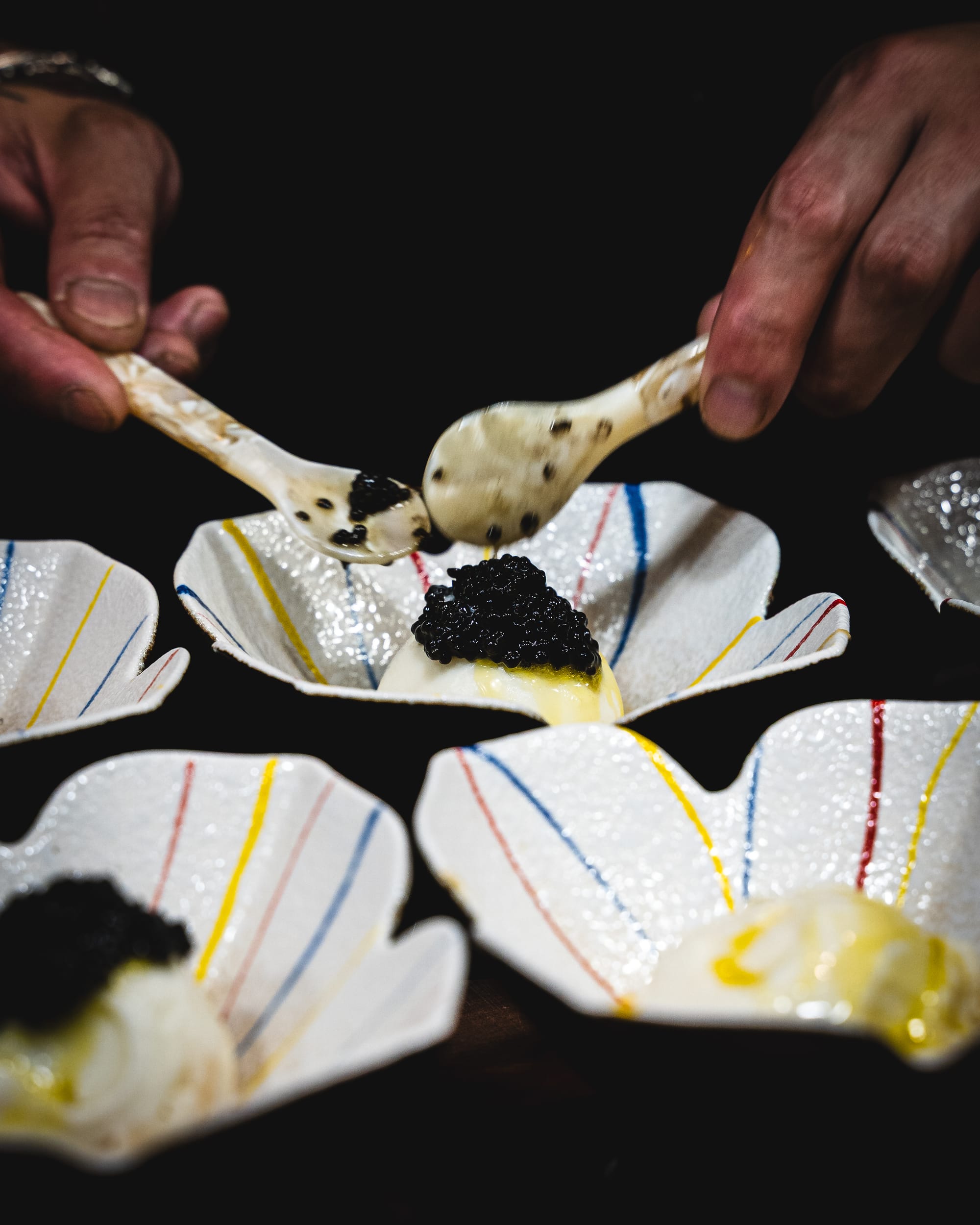 Caviar being spooned on-top of ice-cream