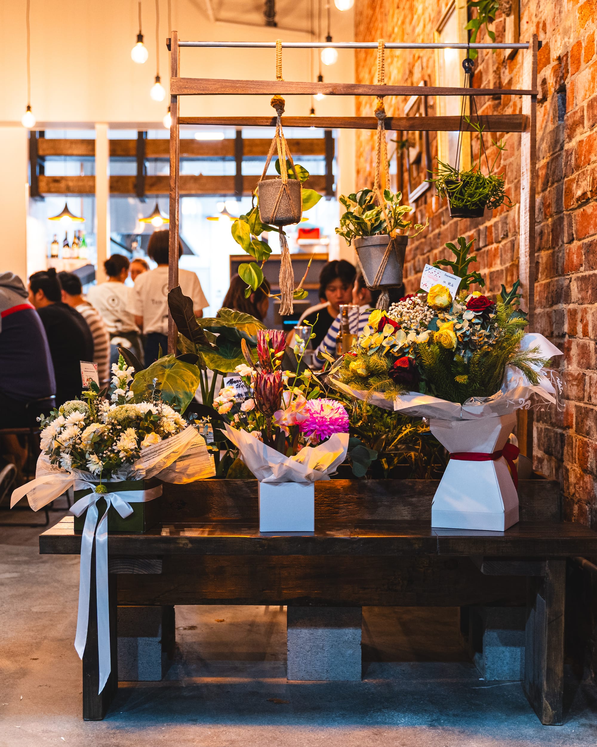 Congratulatory flowers displayed at the front of Ten & Sen