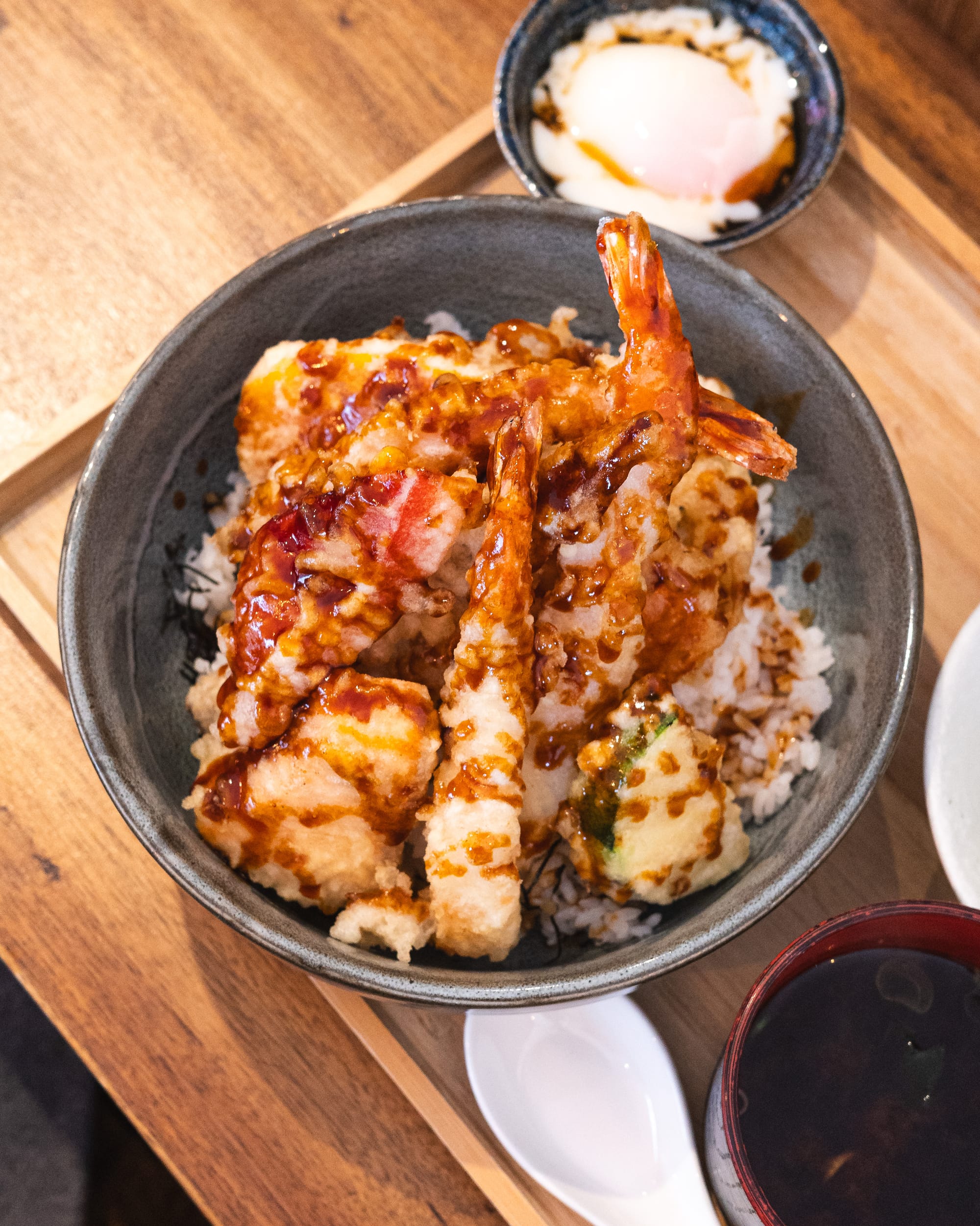 Top down shot of tempura on-top of rice in a bowl