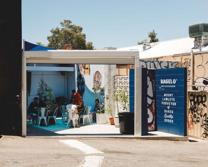 Daytime shot of Bagel O Delicatessen showing their outdoors seating area