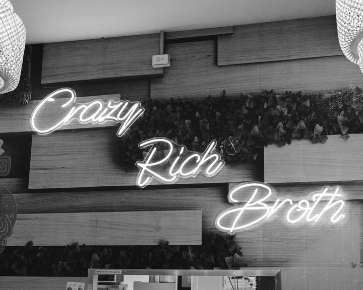 Sign that says "crazy rich broth"