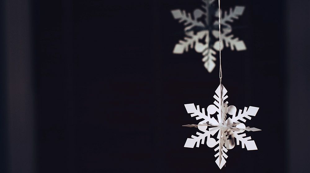 Homemade snowflake hangs in a window