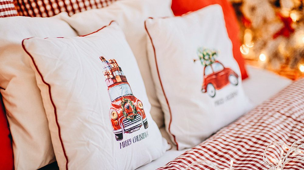 Rustic Christmas pillows in a space decorated for the holiday season
