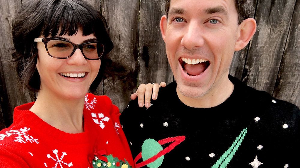 a couple wearing ugly holiday sweaters