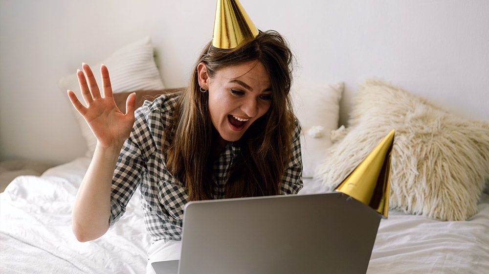 woman using laptop to video chat friends and family