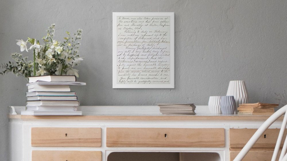 A handwritten note enlarged and print on canvas above a desk