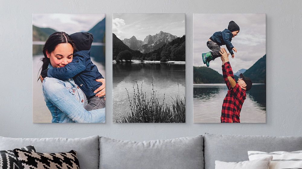 Three large canvas prints above a couch