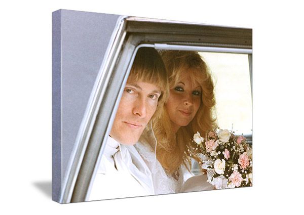 vintage photo of wedding couple with blonde hair sitting in the back of a car