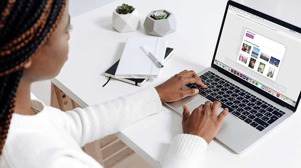 black woman uploading photo to the Canvas On Demand website while on laptop