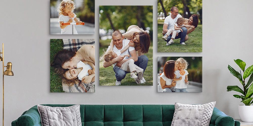 canvas wall display featuring photos of a small family in various poses hanging over a green couch in a modern living space