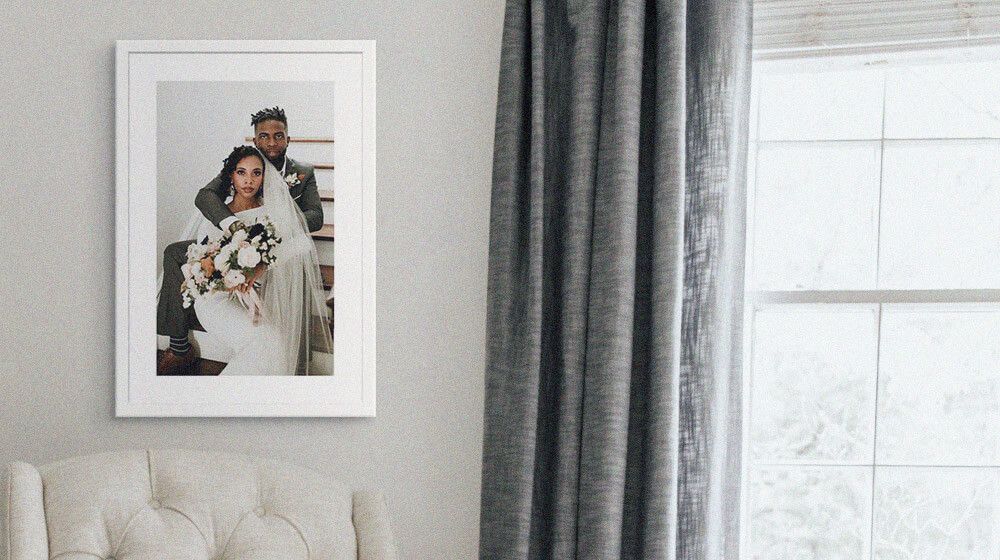 A framed print of a couple's wedding hanging on a wall in a living room