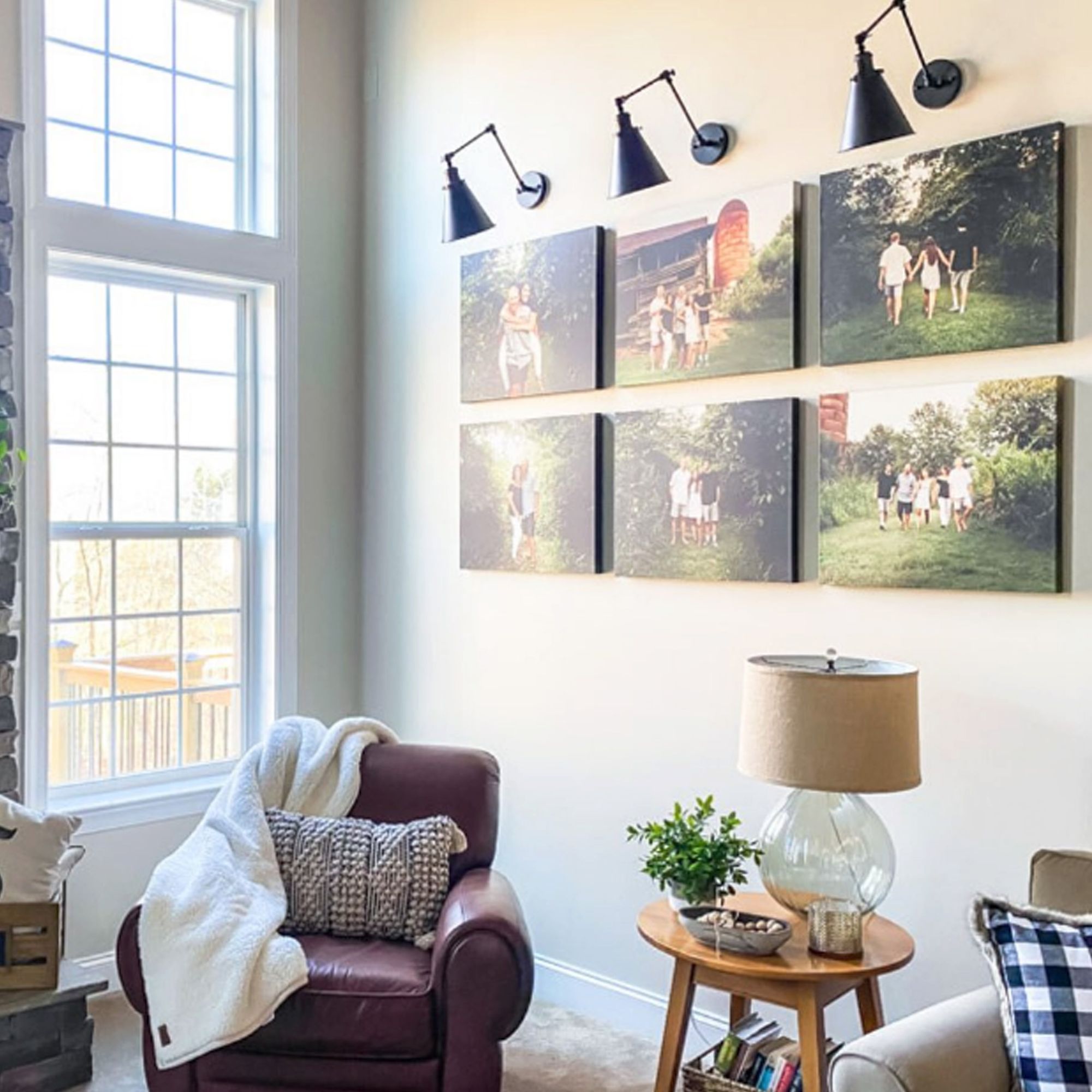 Multiple canvas prints hanging in a living room to create a photo gallery wall