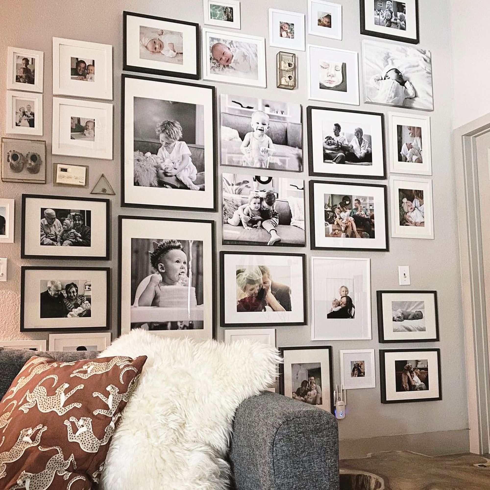 Multiple canvas and framed family prints displayed on a gallery wall
