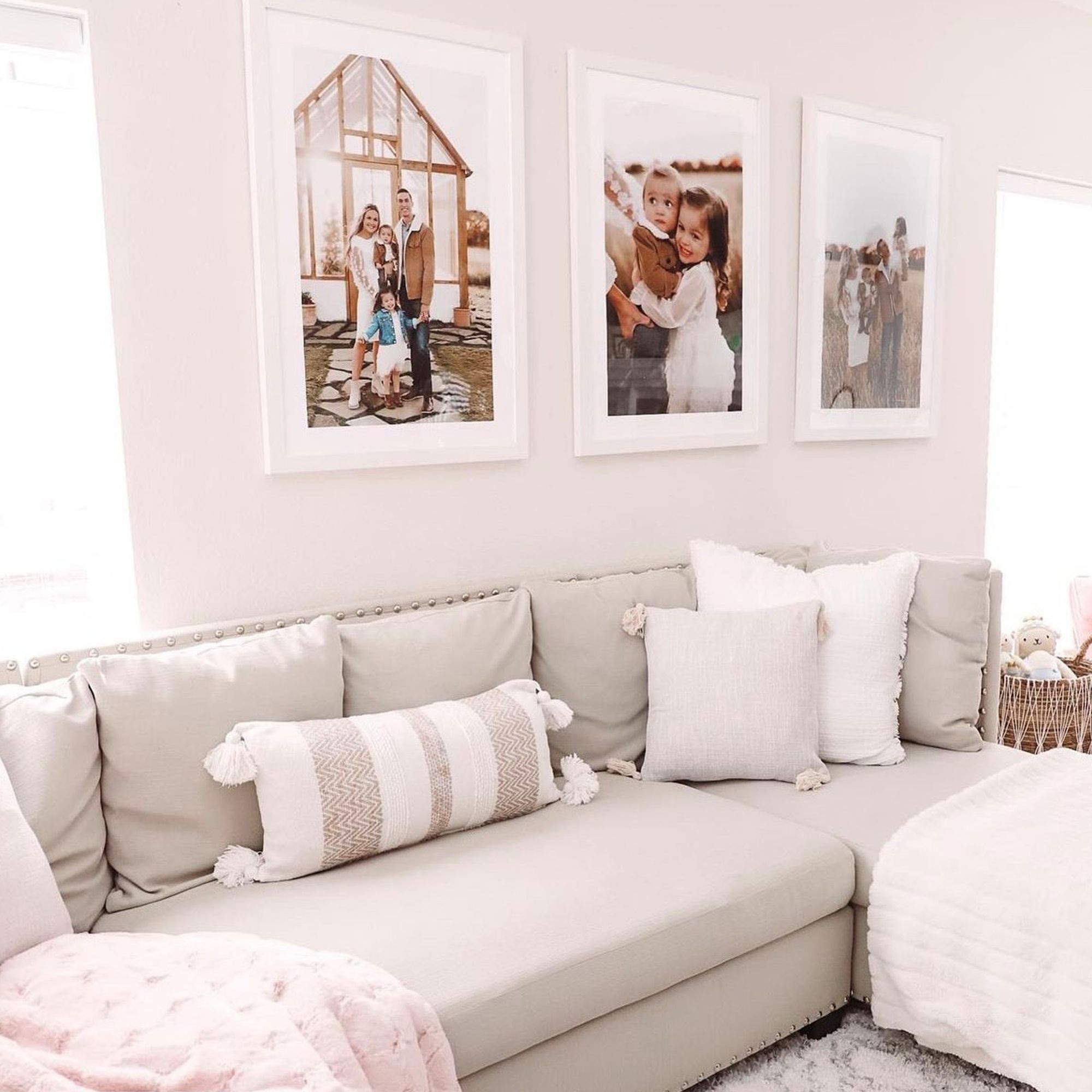 white framed prints hanging over a couch in a three piece photo gallery wall