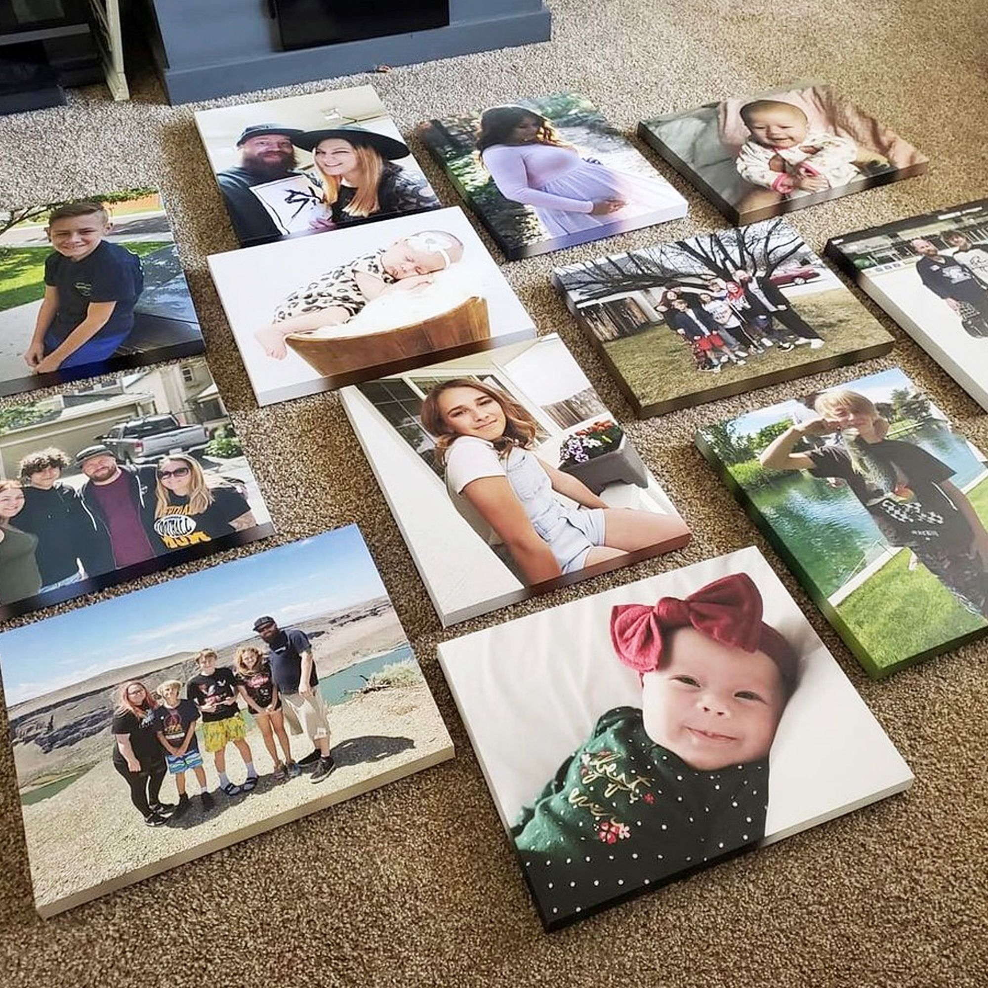 canvas prints spread out on the carpet floor to plan a gallery wall's layout before hanging