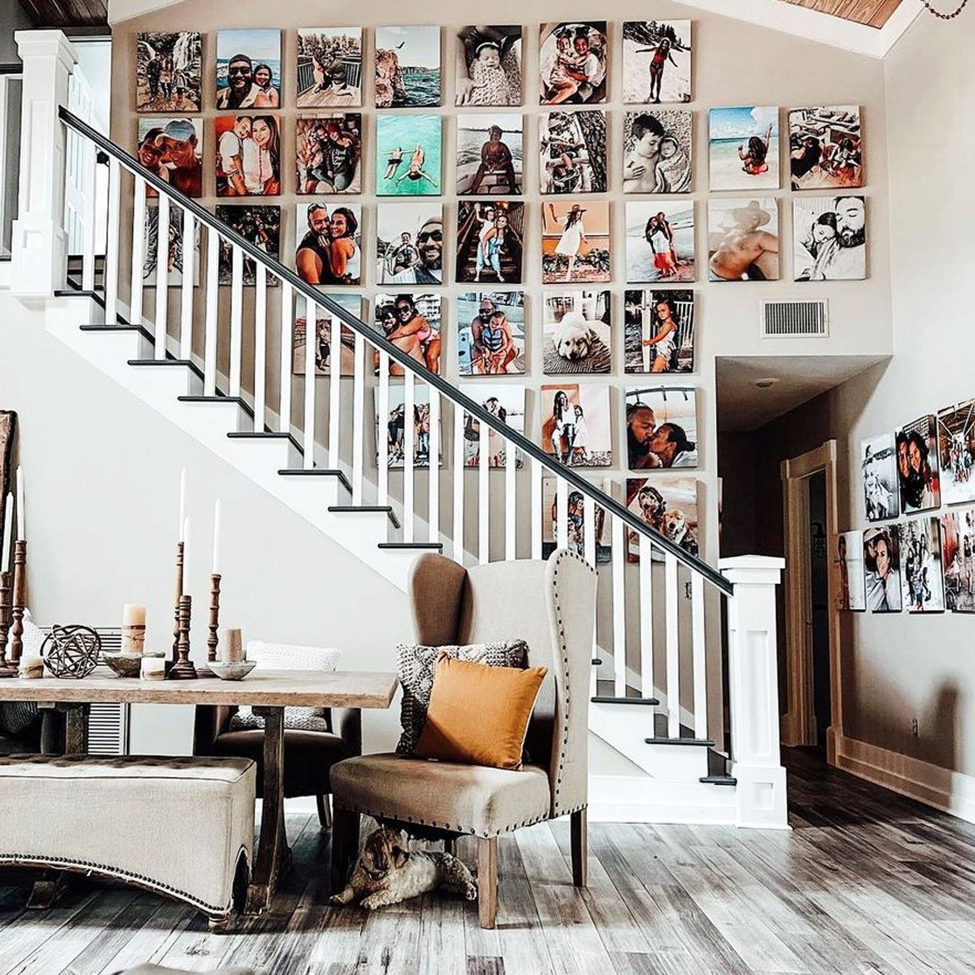 massive photo gallery wall using canvas prints above a staircase