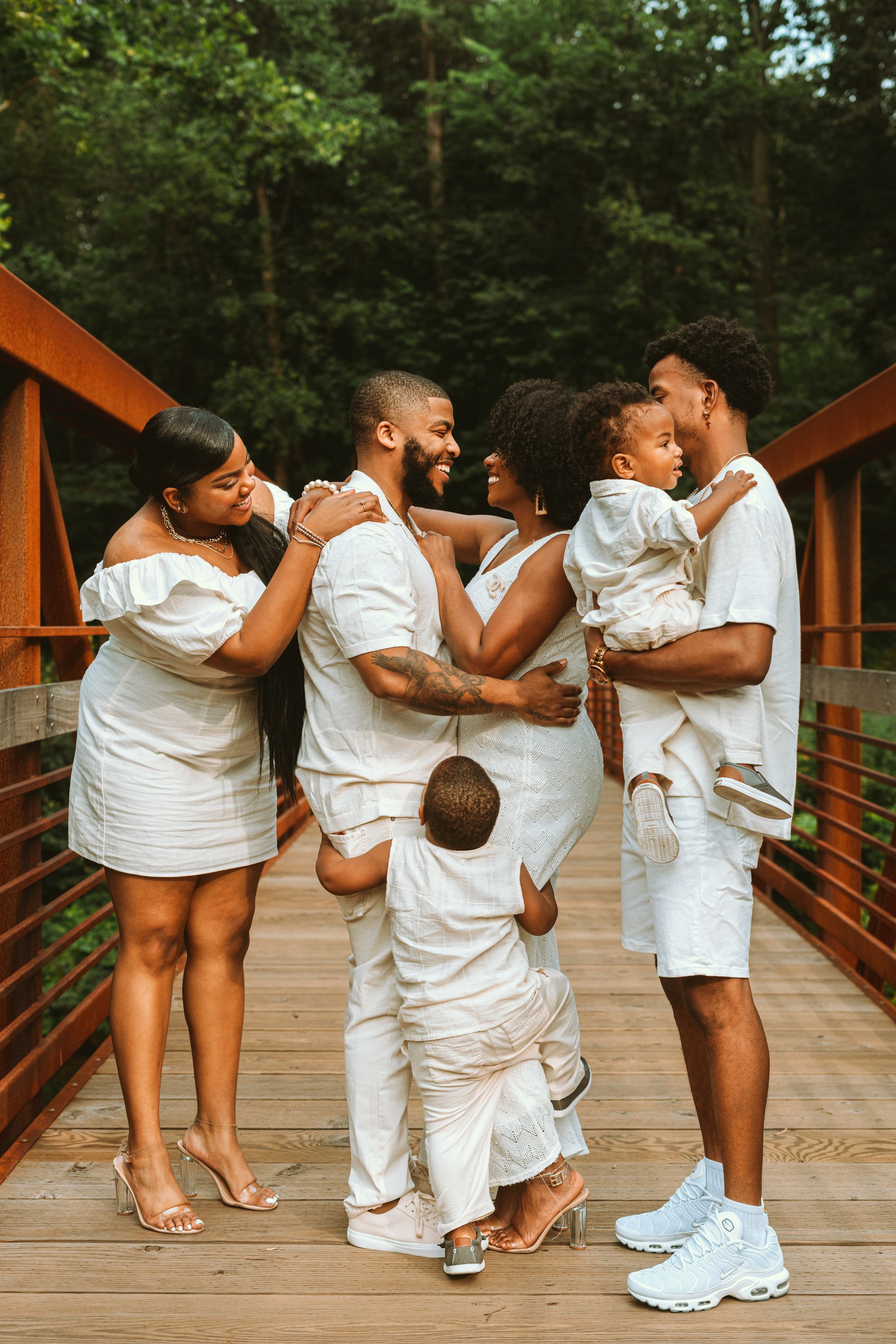 Family facing each other enjoying a funny pose for an outdoor photoshoot