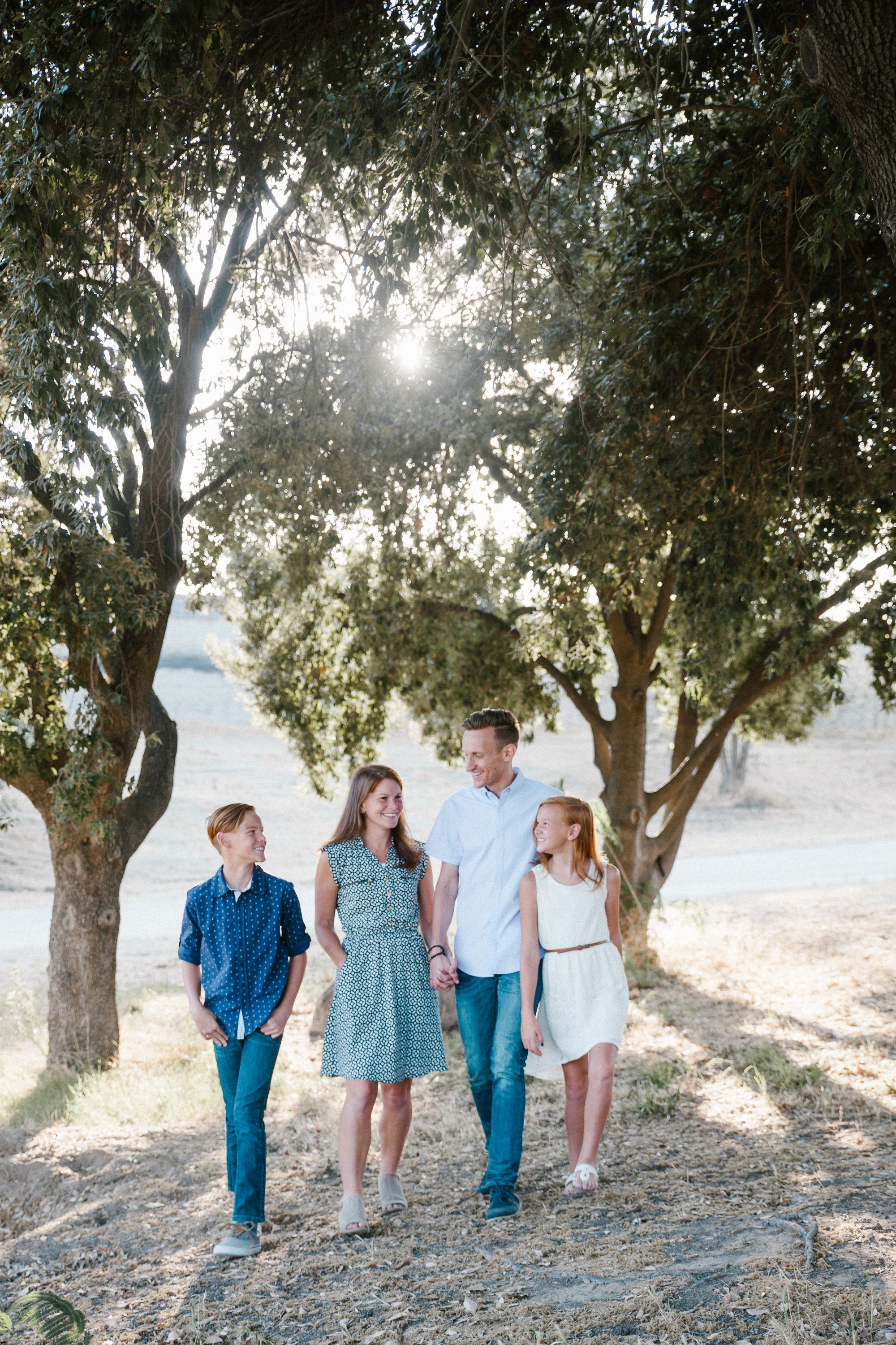 Family walking towards the camera as a pose for an outdoor photoshoot