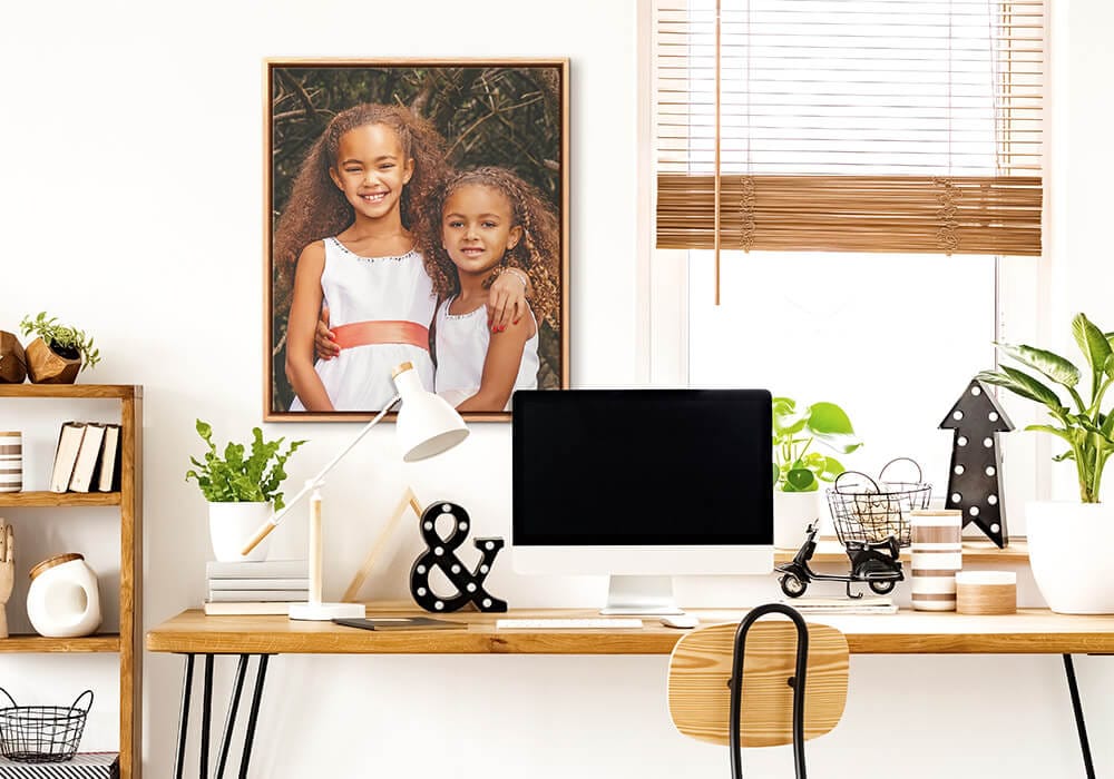 20x24 natural float framed canvas hanging above a desk in a home office