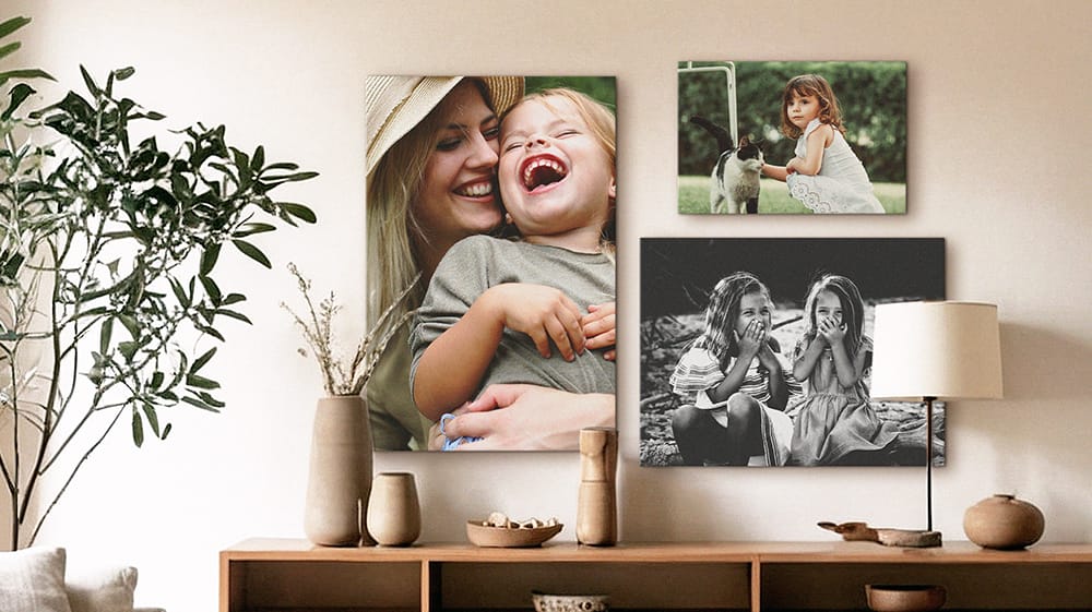 multiple canvas prints of family photos displayed together in living room