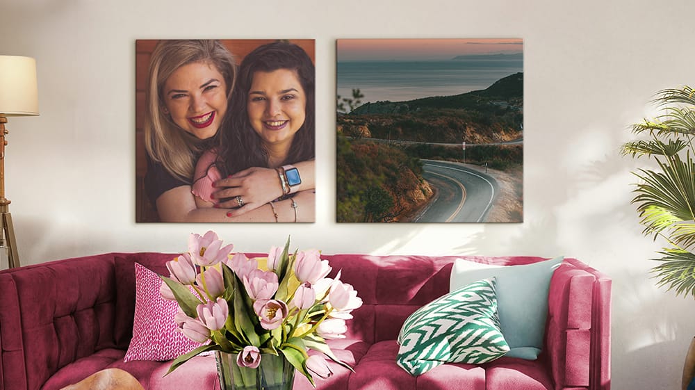 two canvas prints of portrait and landscape photos displayed above couch