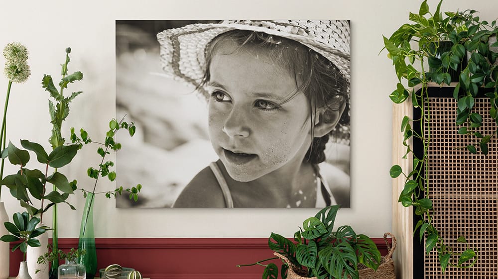 large black and white canvas print of child portrait creating focal point in decorated room