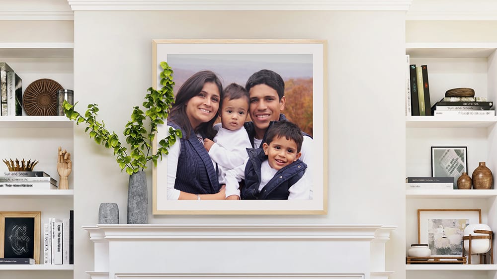 large framed paper print with mat and frame displayed above fireplace