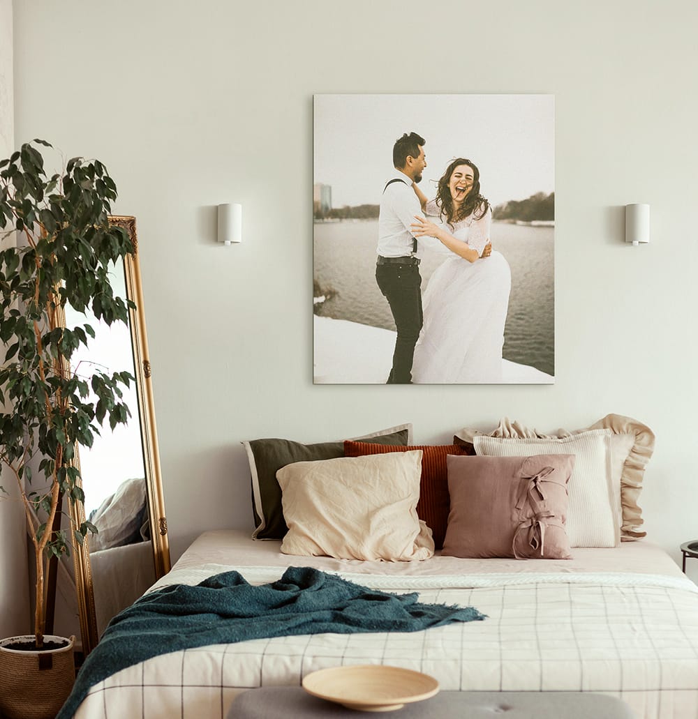 large custom canvas print of couple above bed making bedroom feel open and balanced