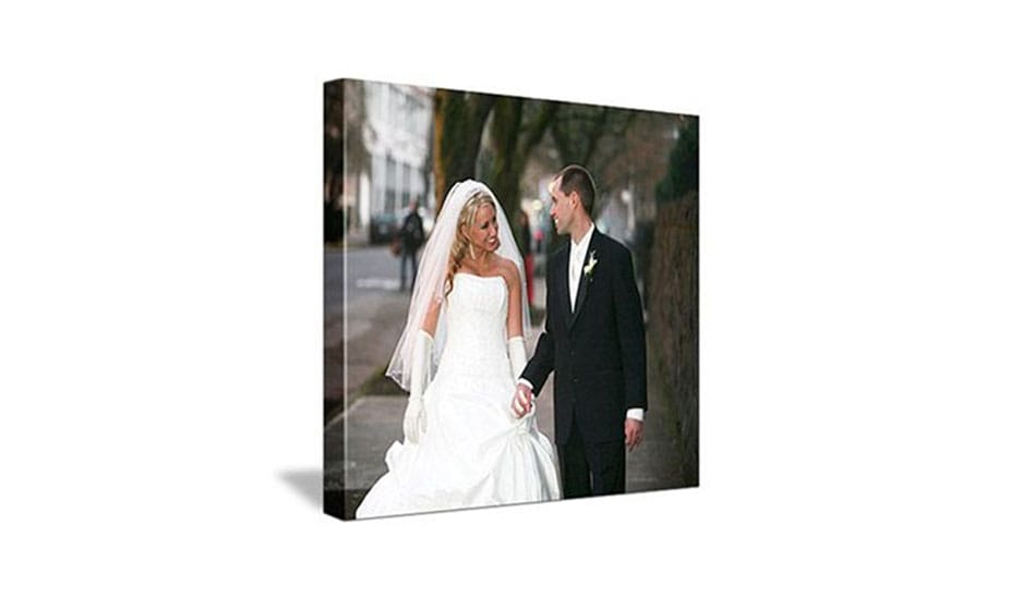 image of wedding couple walking outside underneath trees