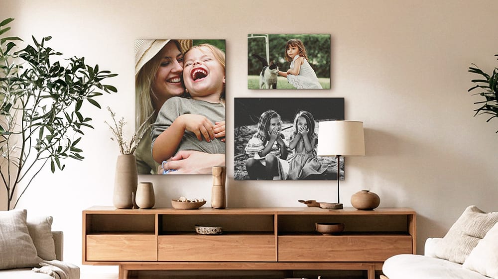 black and white canvas prints of family moments displayed in warm neutral living room