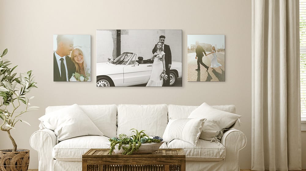 black and white canvas prints of wedding photos displayed above couch in minimalist living room