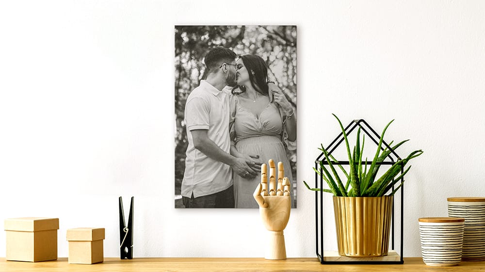 black and white canvas print of maternity portrait displayed on shelf in modern home
