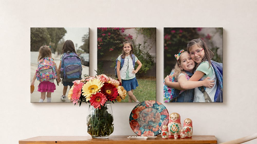 Three canvas prints show two sisters with backpacks on their way to school, posing separately and hugging.