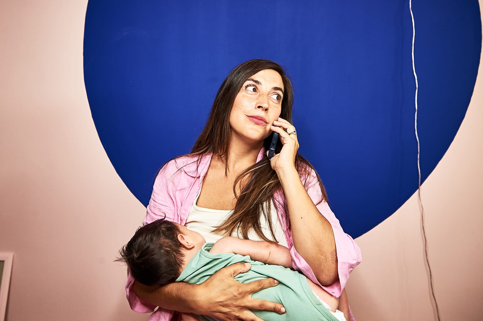 The author breastfeeding and on the phone, as referenced in the story