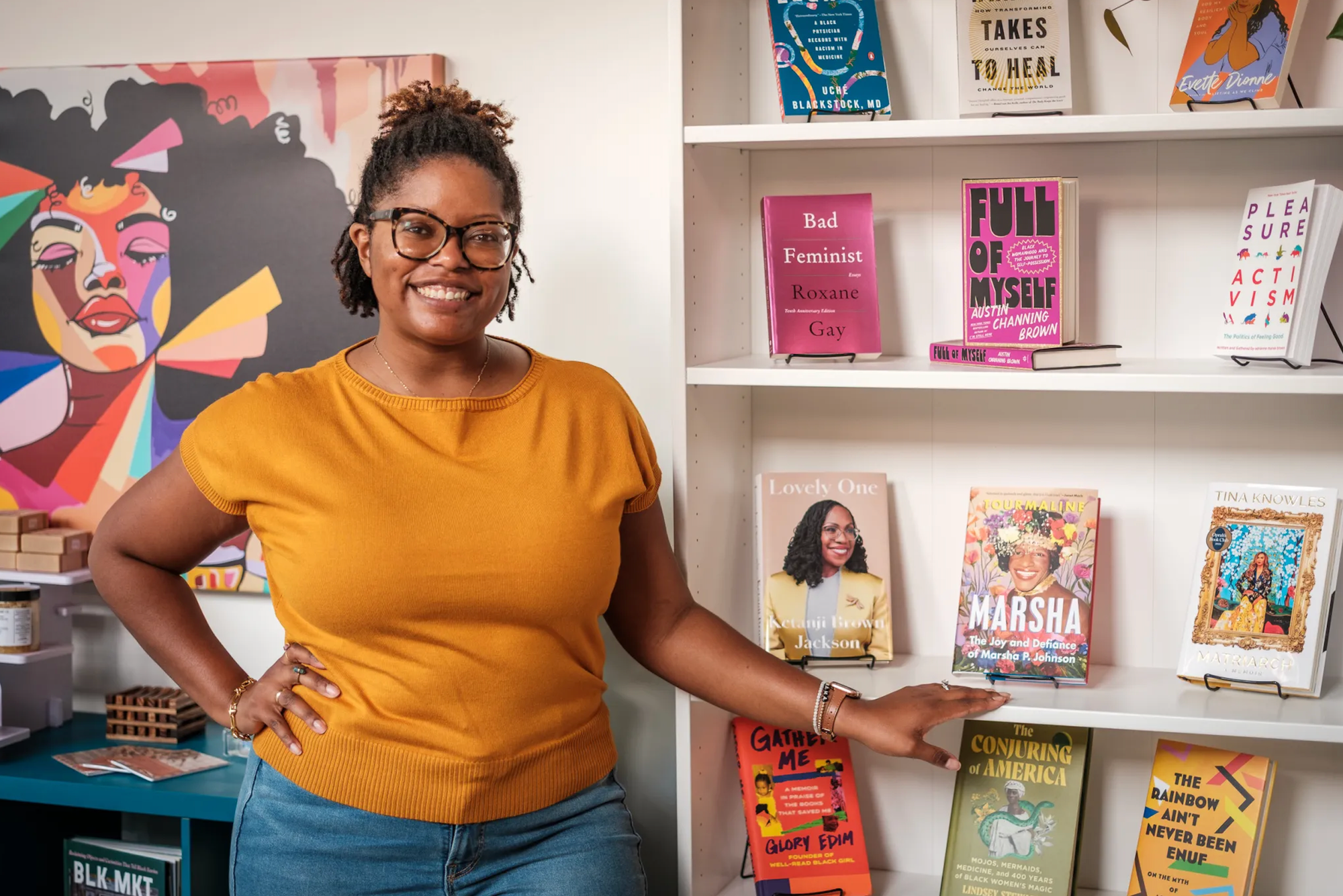 The author at the grand opening of Zora's Place surrounded by books—photo by Joerg Metzner