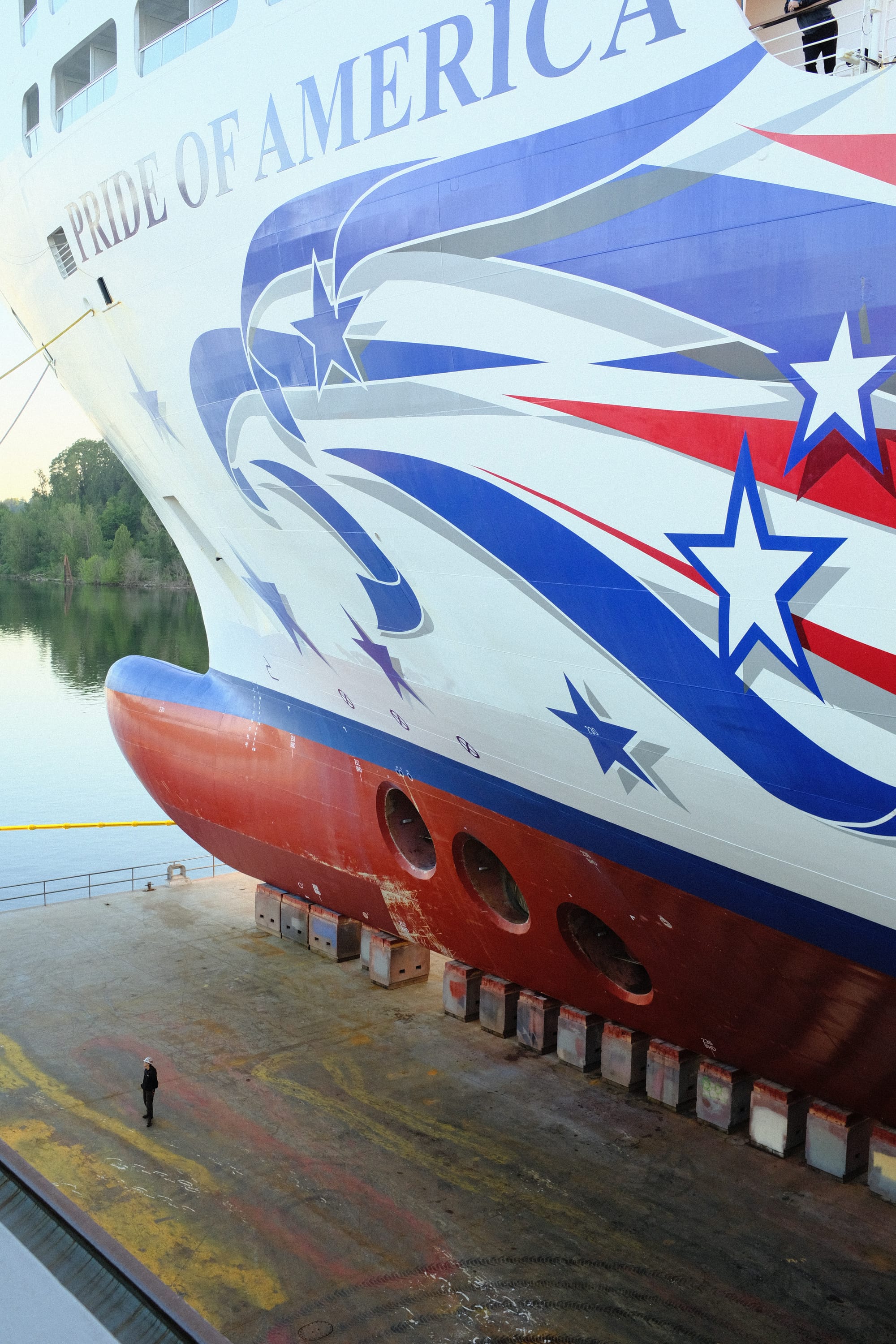 A huge cruise ship in a dry dock. The graphic says "pride of america" and there's an eagle graphic.