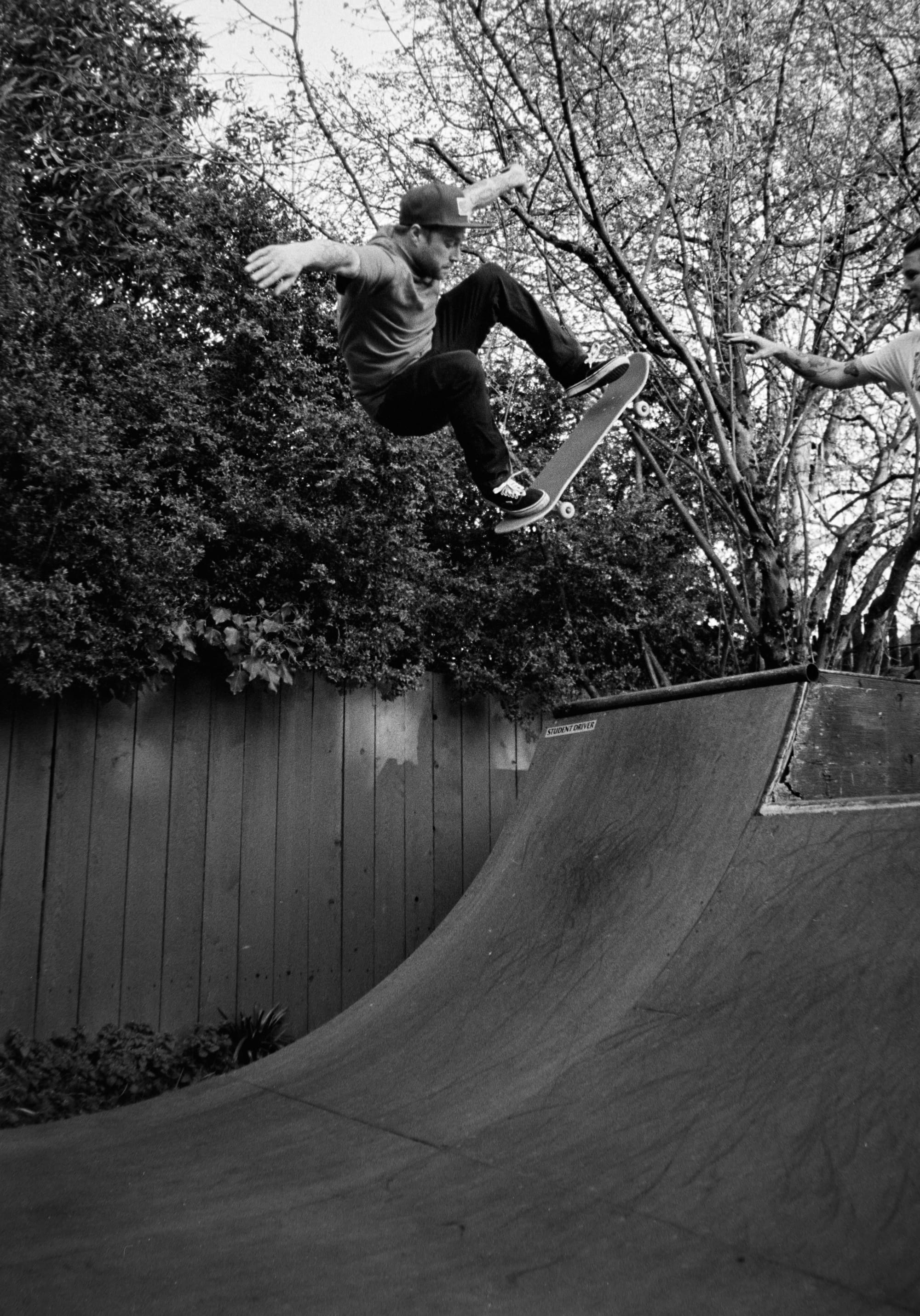 black and white photo of a regular footed skateboarder doing an ollie to fakie