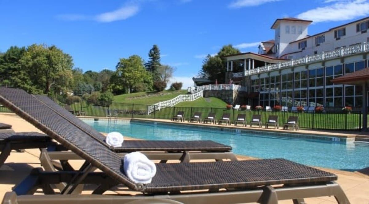 Poolside at the Summit Inn in Summer with Pool chairs and Inn in the background