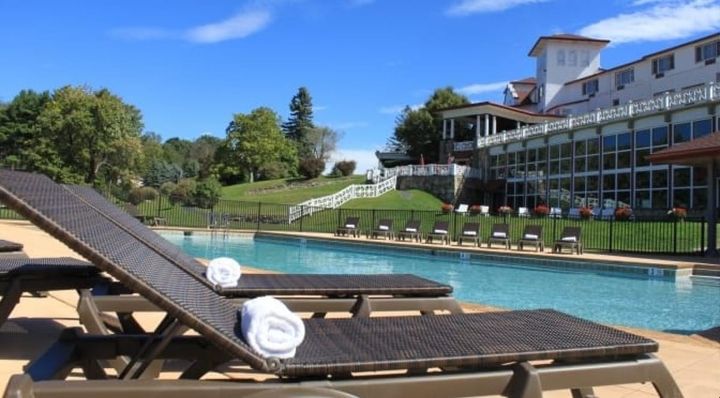 Poolside at the Summit Inn in Summer with Pool chairs and Inn in the background