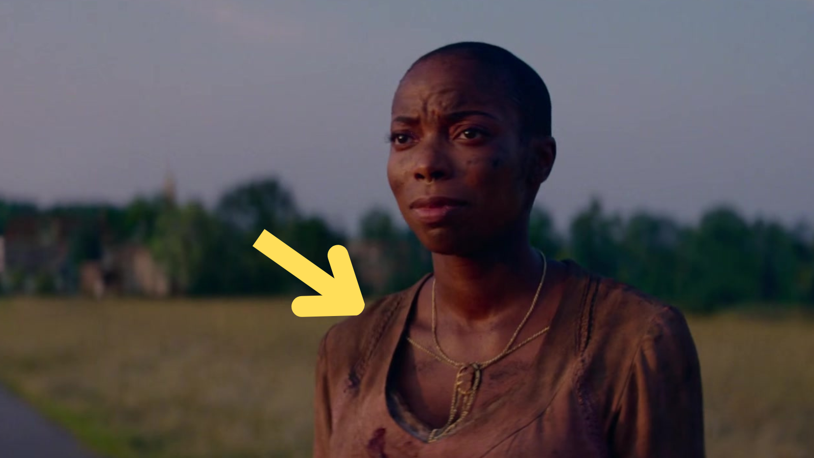 Jennifer Kale at the end of Agatha All Along with an arrow pointing to her ruined dress and necklace.
