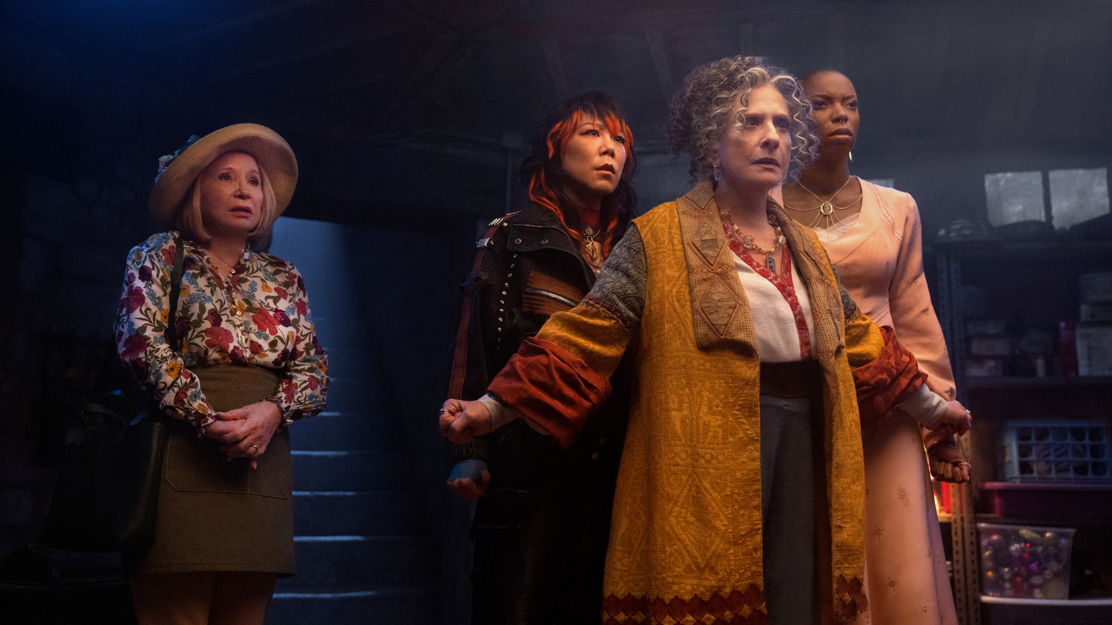 Sharon standing to the side while Lilia stands protectively in front of Alice and Jennifer