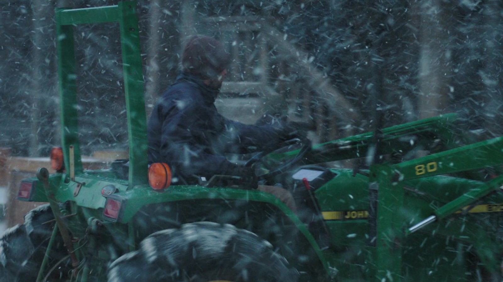 A picture of someone in Jackson using a clearly labeled and well kept John Deere tractor to fortify the wall in episode two.