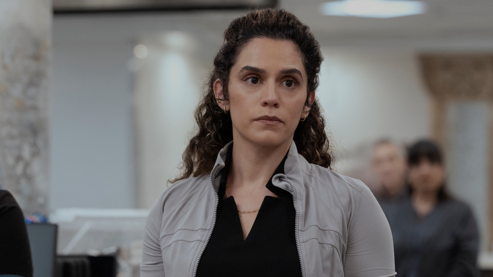 Dr Al-Hashimi early on in The Pitt Season two. Her hair is back in a half ponytail and she's wearing a Lululemon jacket over her scrubs.