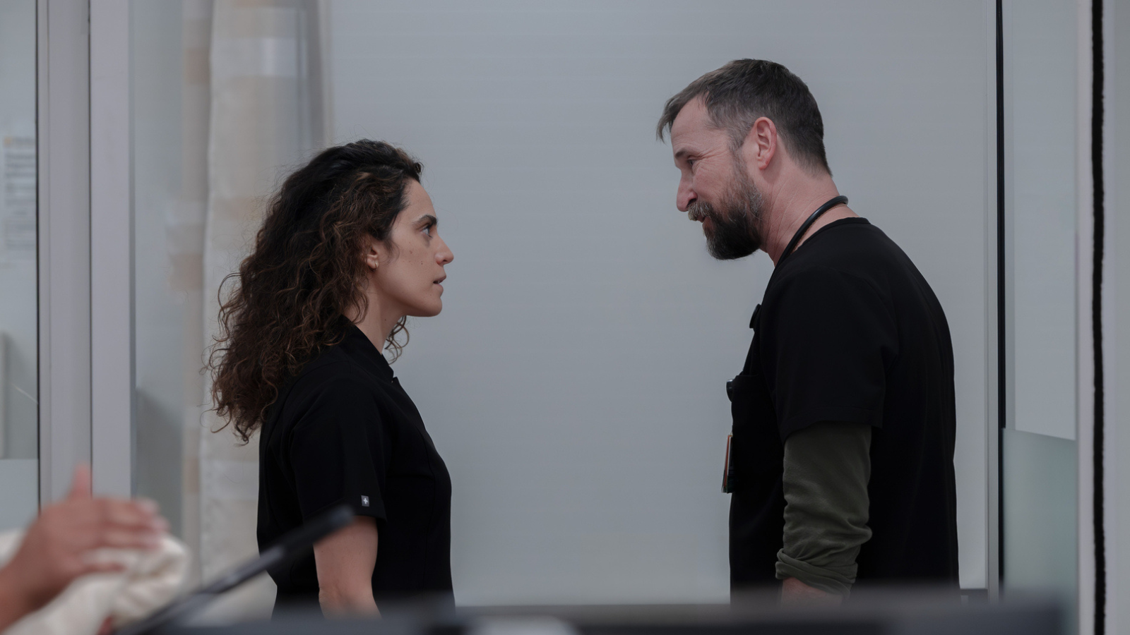 Dr Al-Hashimi at the end of season two where she is now in a dark short sleeved shirt that matches Robby's scrubs.