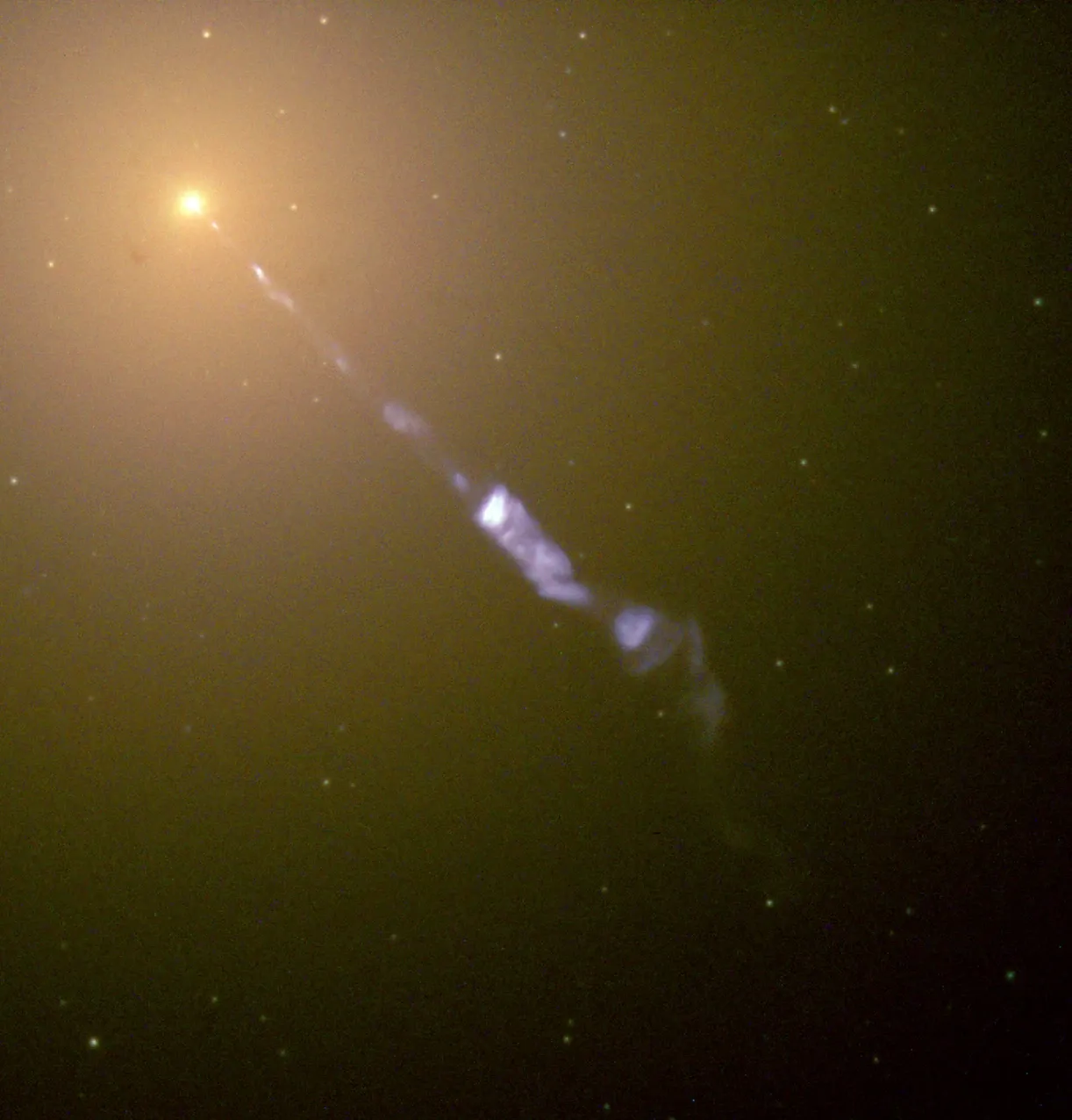 A blue jet extends diagonally from a bright galactic nucleus into the softer golden light of M87.
