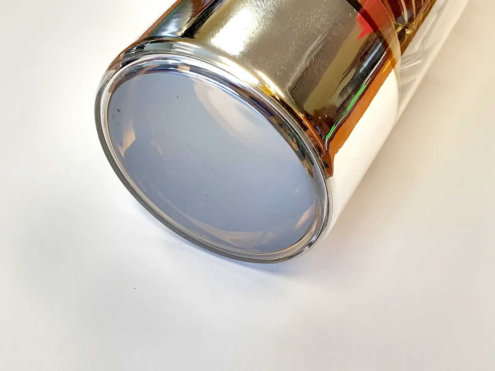 The circular glass face of a photomultiplier tube fills a close-up photograph.